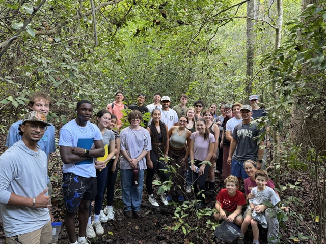 Students gather in the forest during a Biology of Lower Vertebrates field trip.