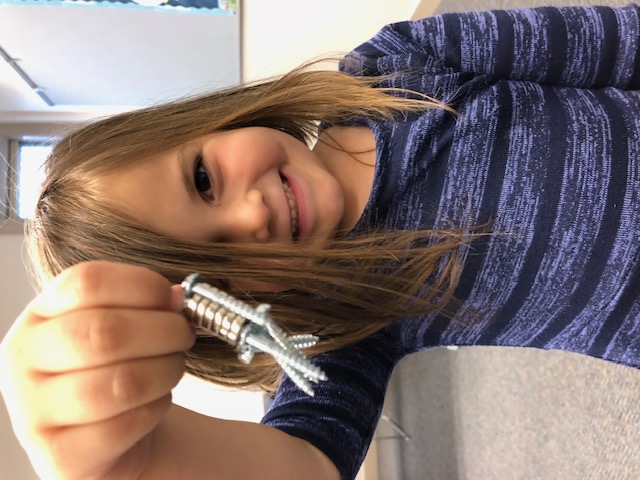 Outreach: Young scientist examining a specimen up close