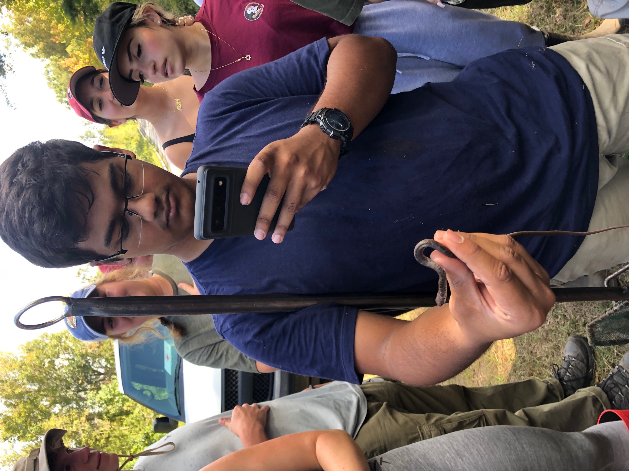Examining a small snake in the field