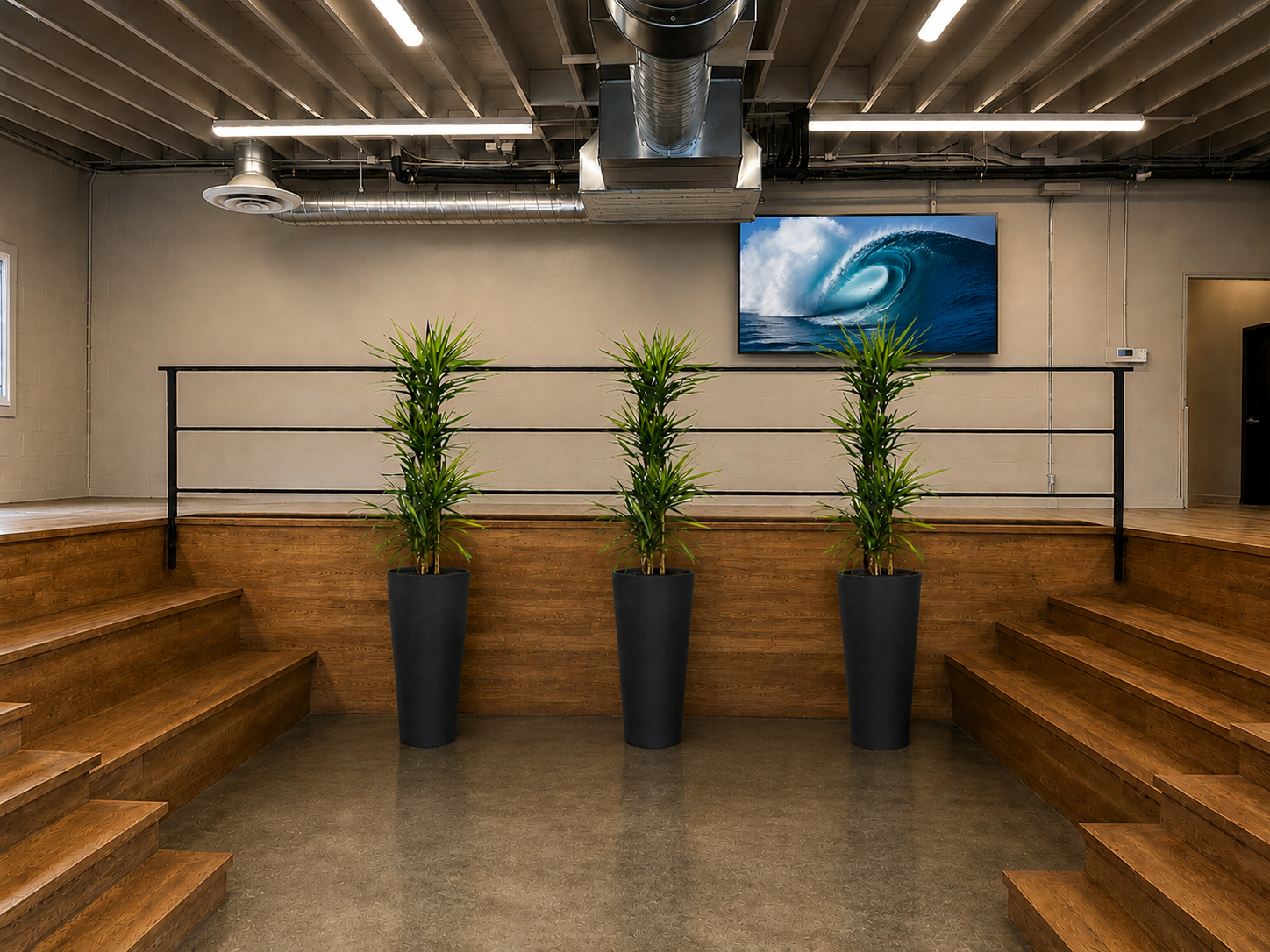 The stage at The Visionary — tiered seating, polished concrete floor, and indoor-outdoor flow