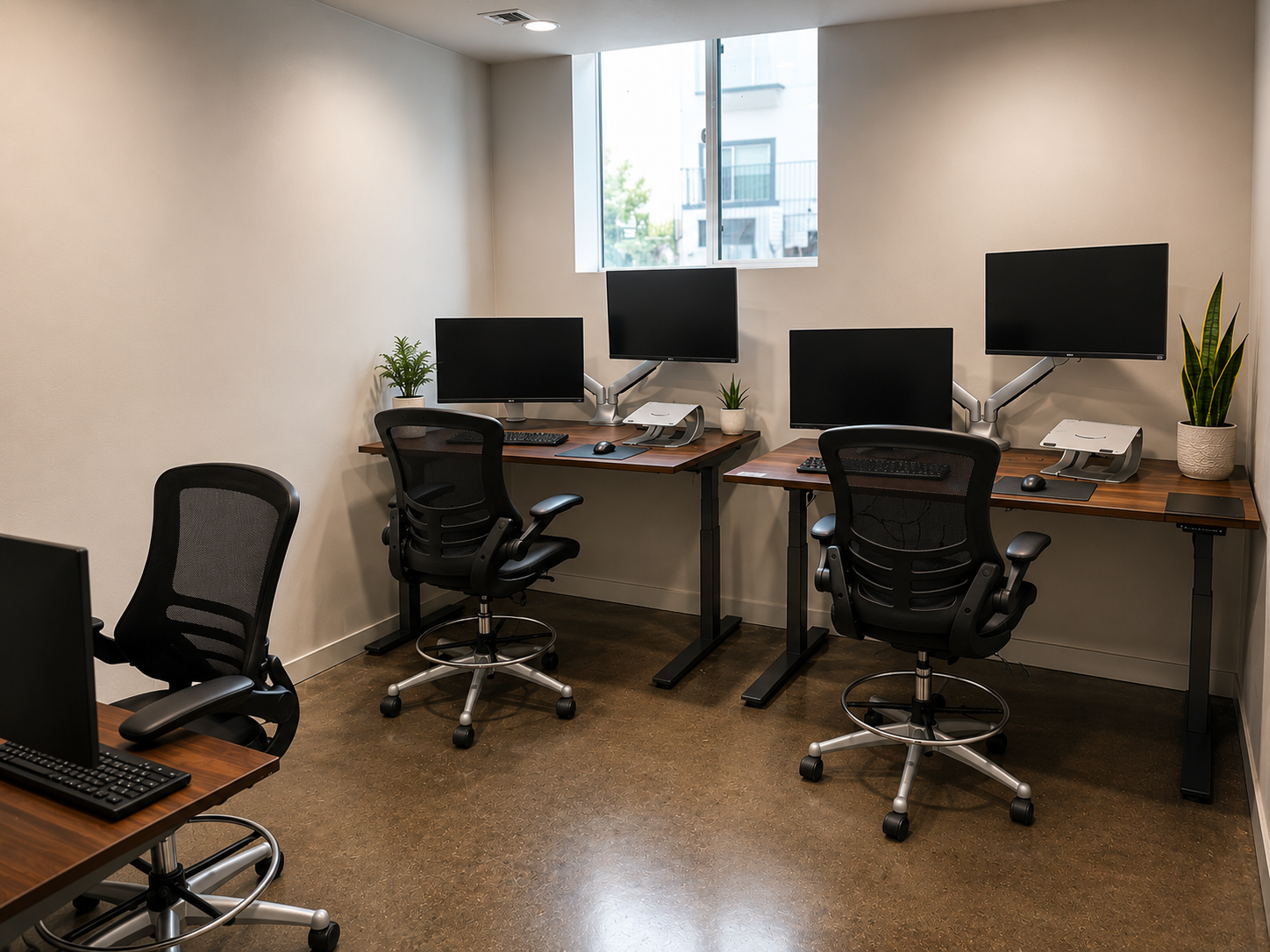 3-person shared office at The Visionary — L-shaped standing desks, dual monitors, and natural light