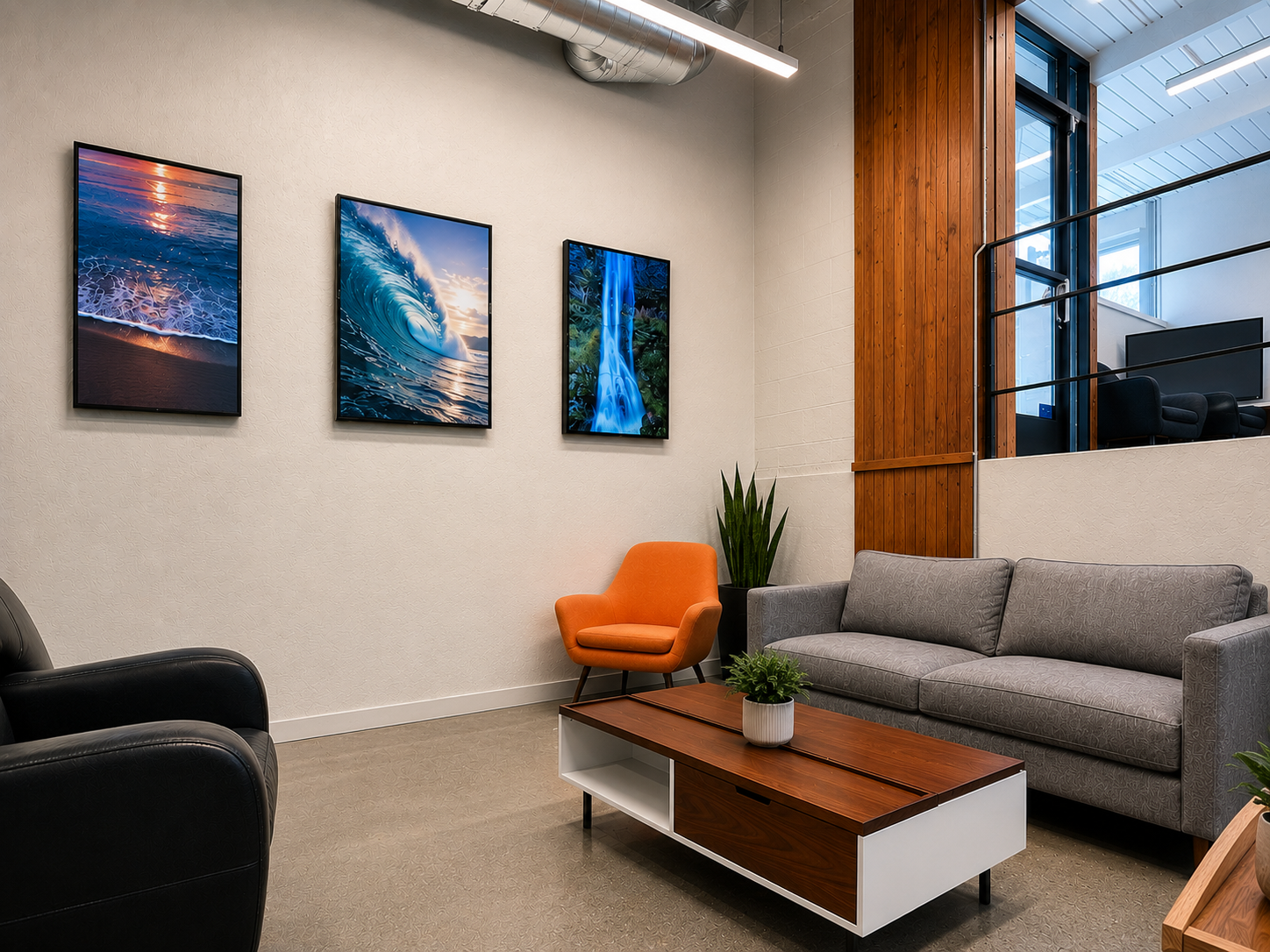 Middle collaboration lounge at The Visionary — sofa, accent chair, and ocean art