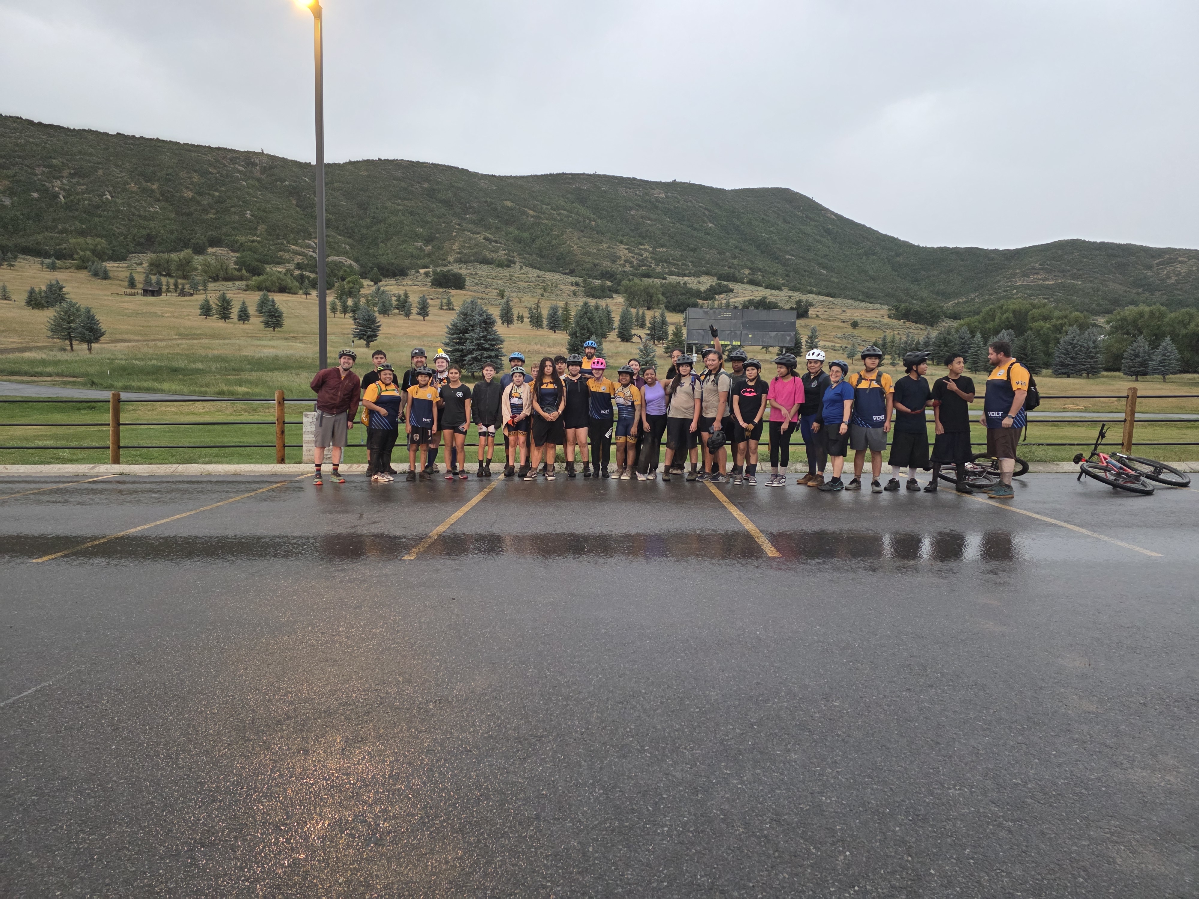 Team lined up in the parking lot on a rainy day