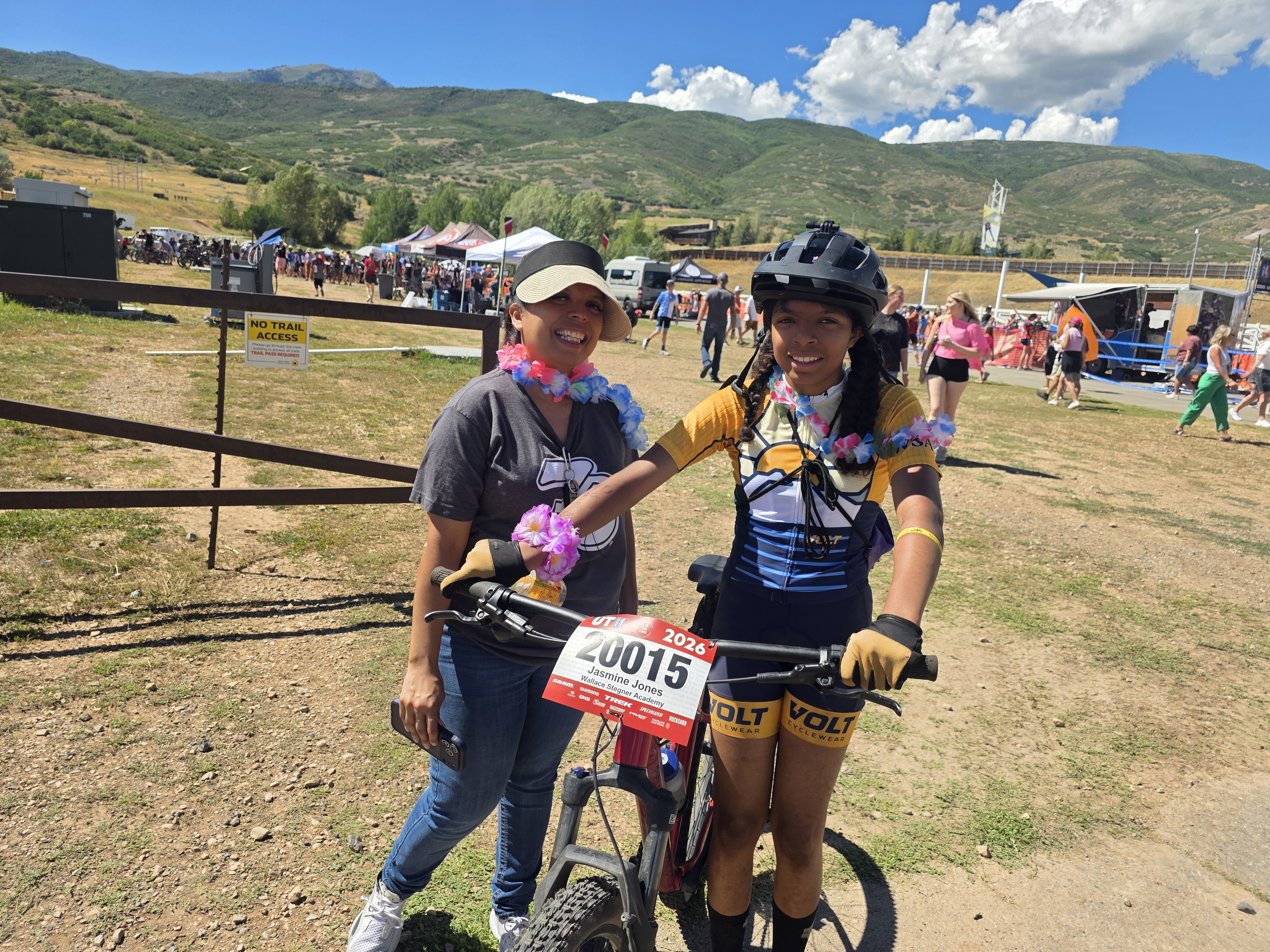 Rider with her race number plate and a supporter