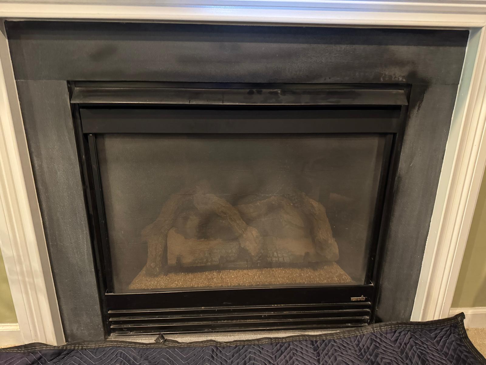 Gas fireplace before repair showing foggy glass and non-functioning burner in Fairfax VA home