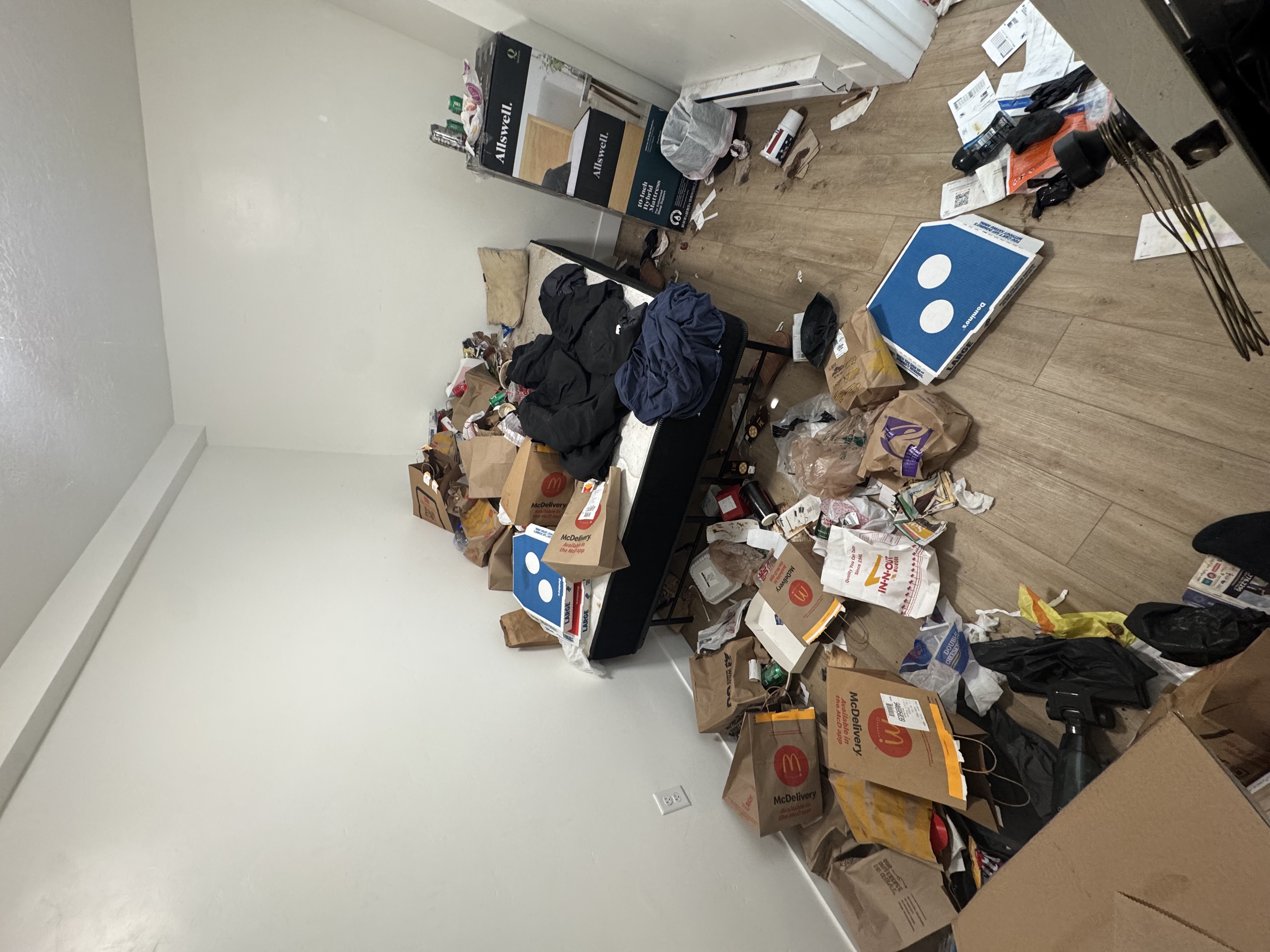 Before: cluttered bedroom piled with trash, fast-food bags, and clothing