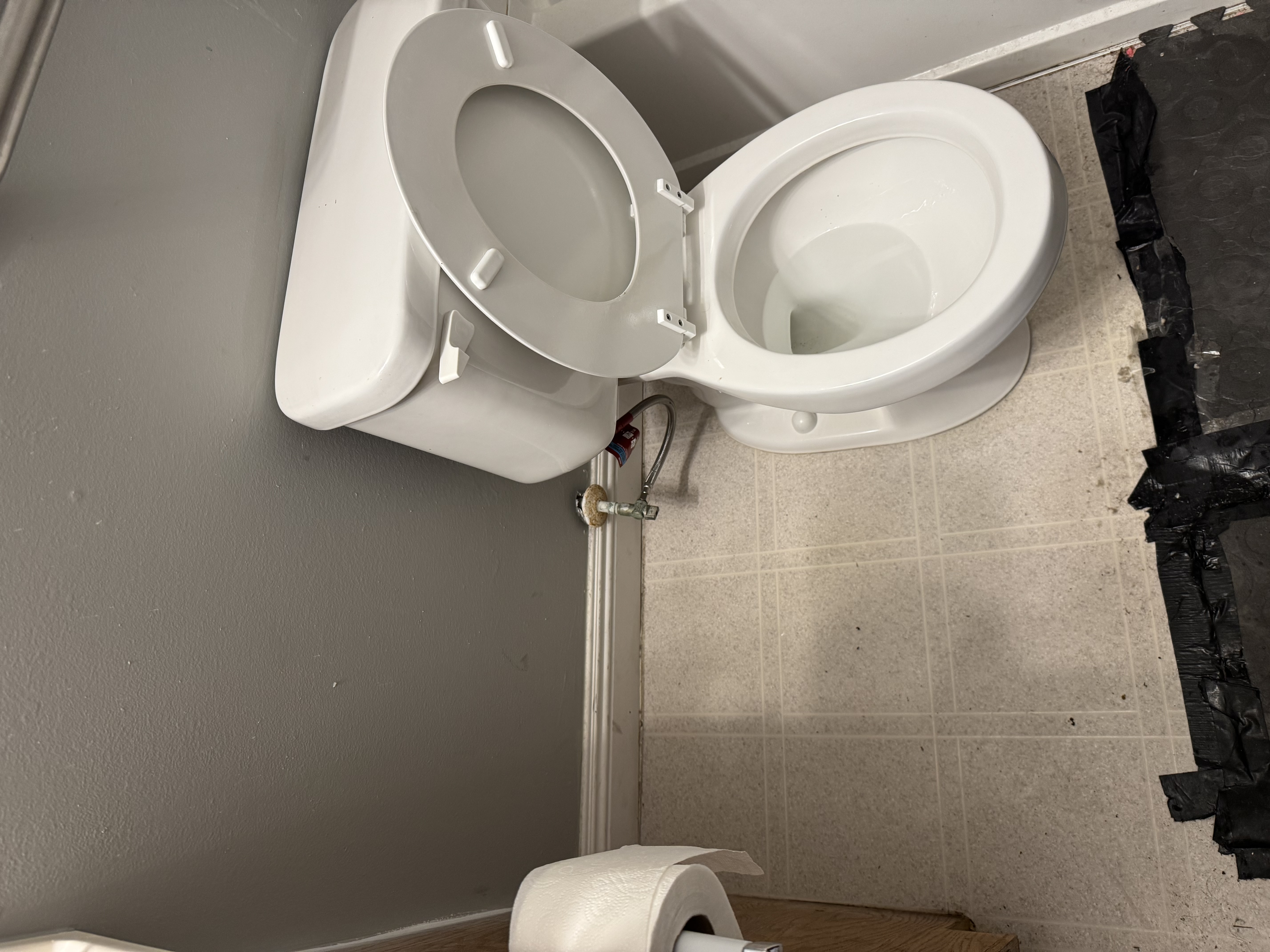 New white toilet installed and plumbed in during a handyman fixture swap by Turnkey Property Services
