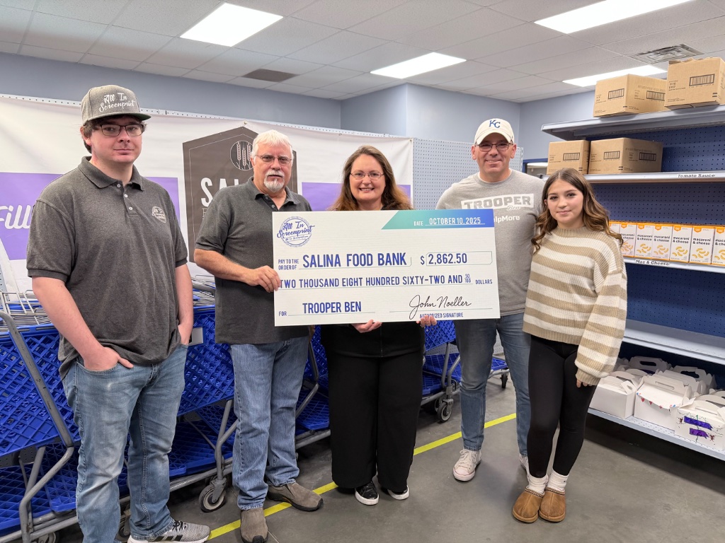 Trooper Ben presenting a check to Salina Food Bank