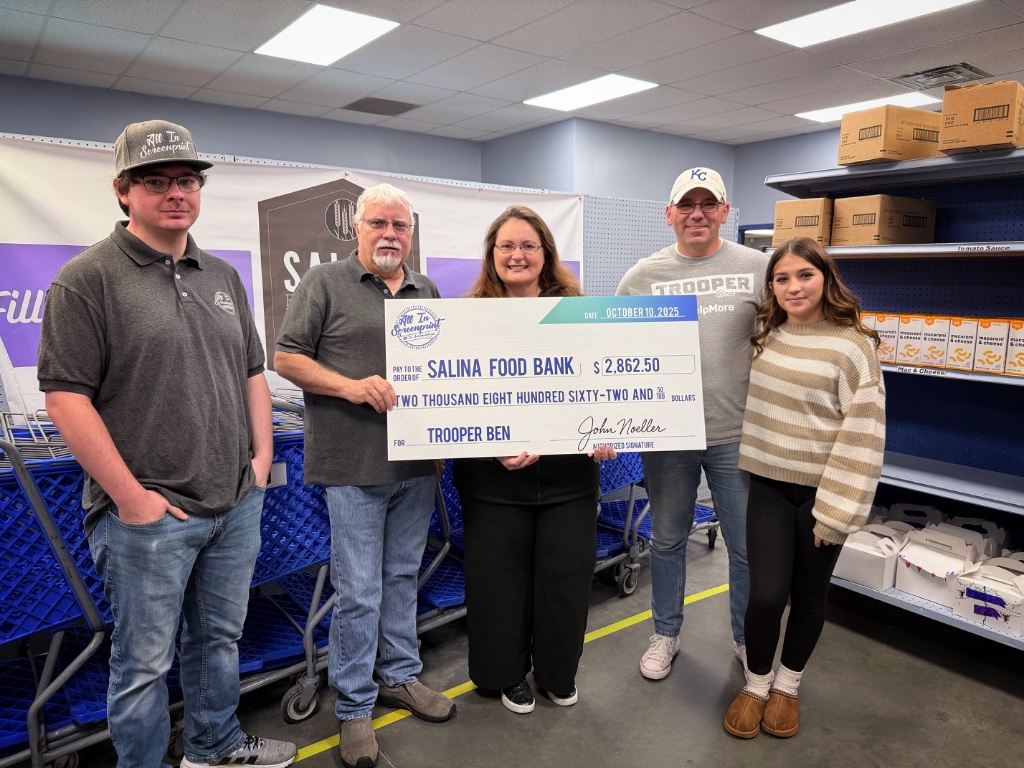Trooper Ben donating $2,862.50 to Salina Food Bank, October 10, 2025