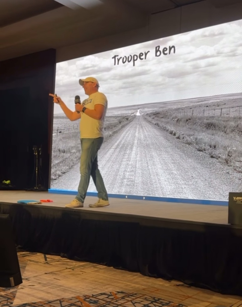 Trooper Ben speaking at a conference