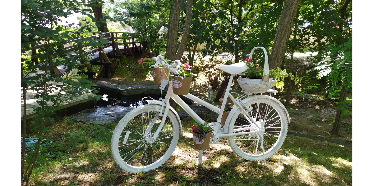 White bicycle in front of the wooden bridge