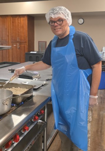 Participant in an apron at a volunteer kitchen worksite