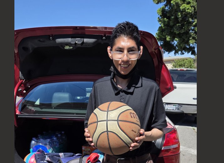 Ivan holding a basketball after a game