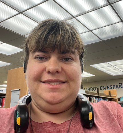 A WCP participant smiling in the program library