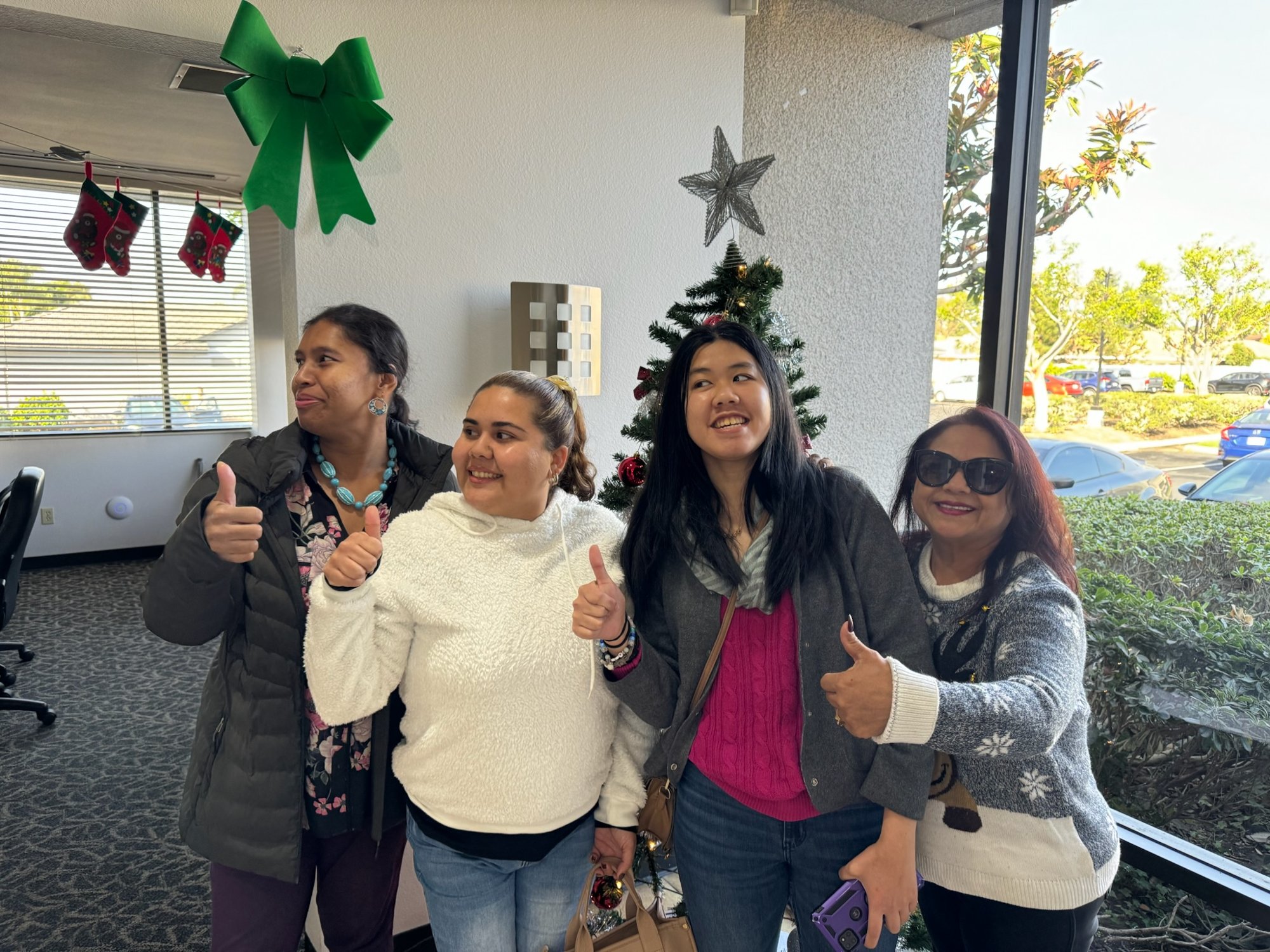 Work Creation Program participants giving a thumbs-up together during the day program
