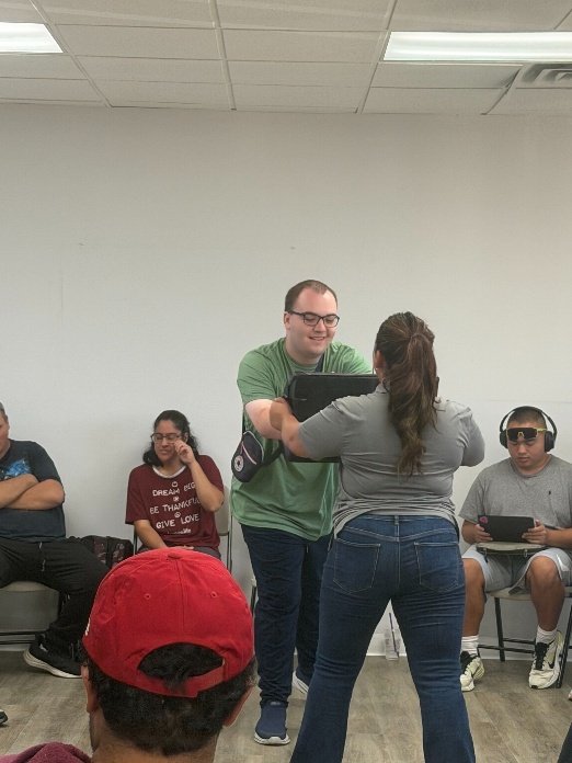 Instructor and participant practicing a hands-on safety skill