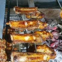 Charcoal grill dishes fresh from the kitchen at The Posh Public House