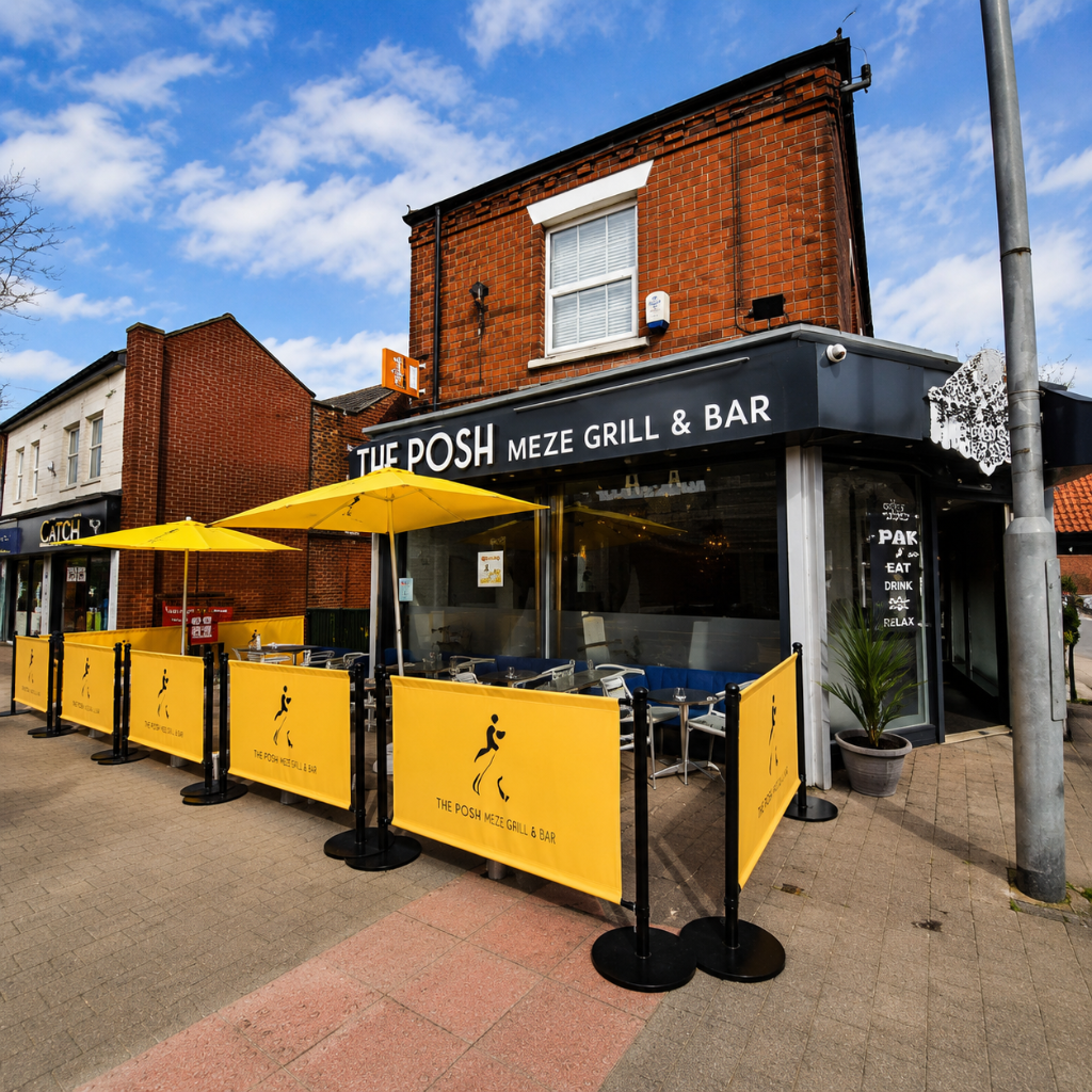 The exterior of The Posh Public House with outdoor seating in Kirkby-in-Ashfield