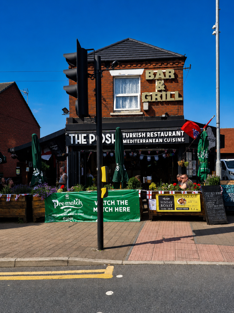 The Posh Public House exterior with outdoor seating and chalkboard menu