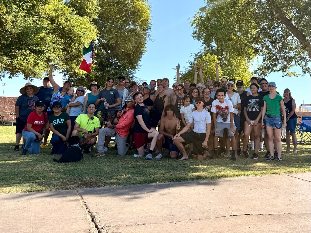 Desert Juggernauts community group photo with Mexican flag at a Bullhead City race event