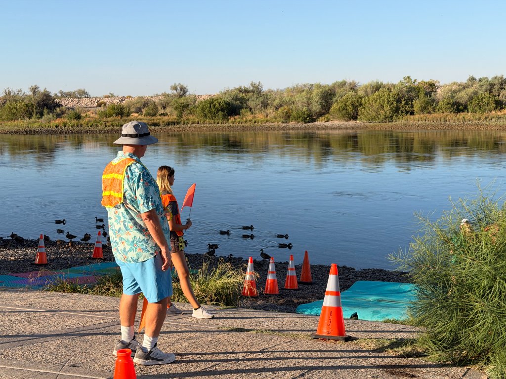 Desert Juggernauts volunteers in safety vests by the river at a Bullhead City race