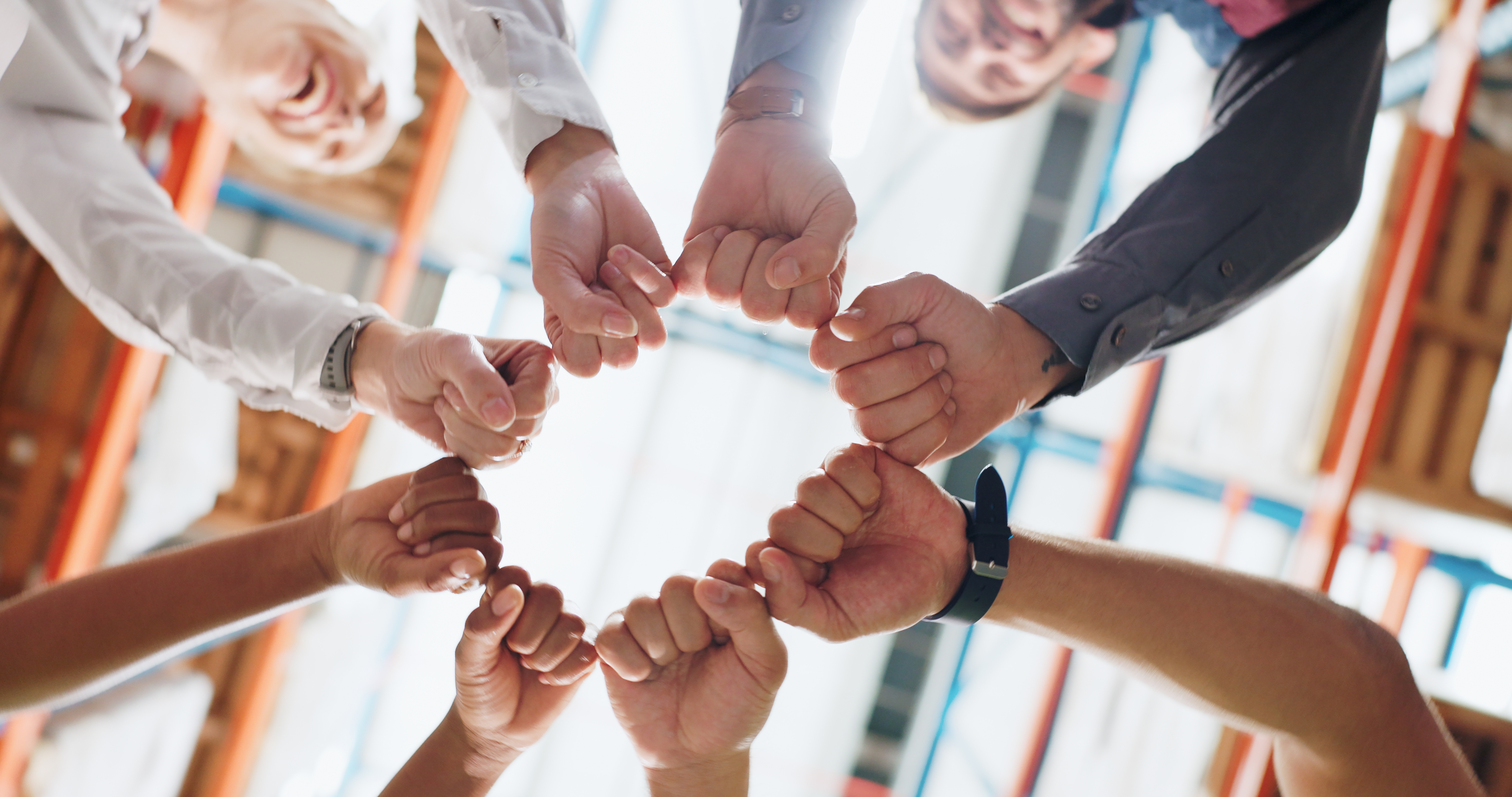 Diverse team showing unity with a fist bump