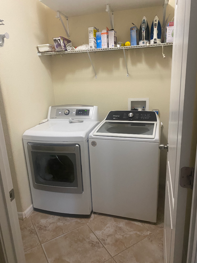 Laundry closet with Whirlpool front-load dryer and top-load washer
