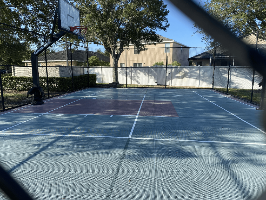 Community basketball court with Goalrilla hoop and tiled surface