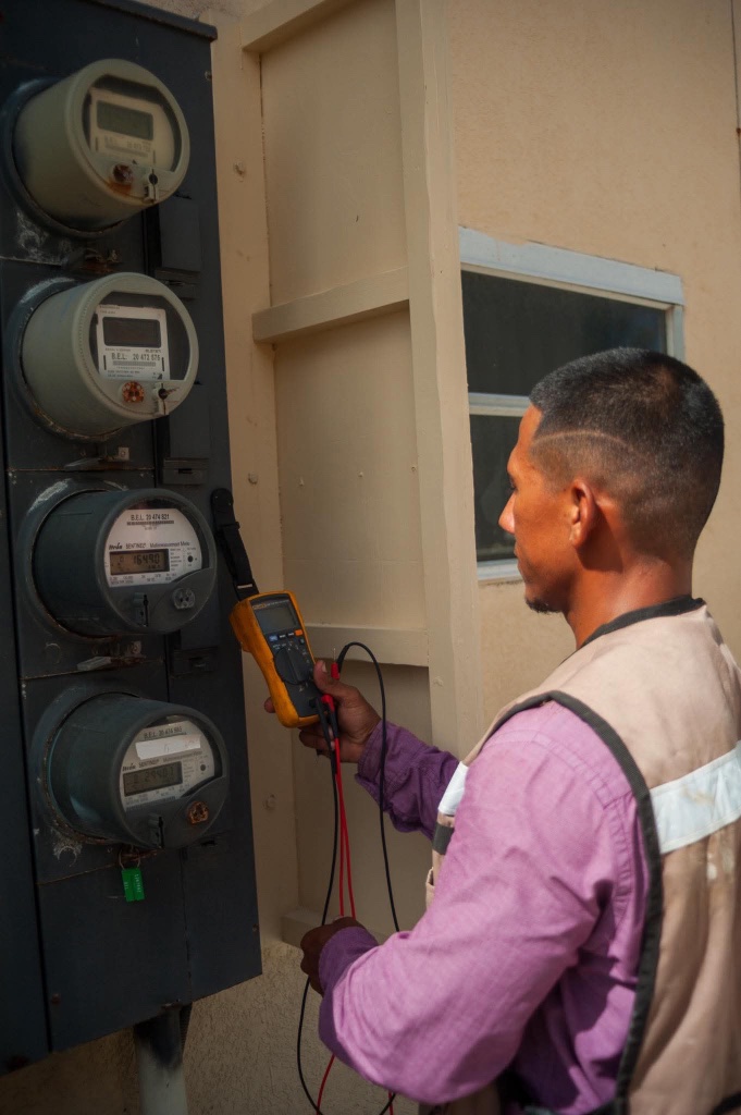 Electrician testing utility meters