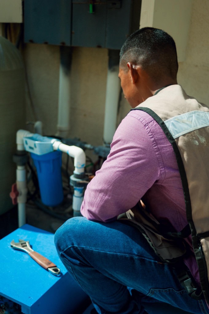 Plumber servicing water filtration system