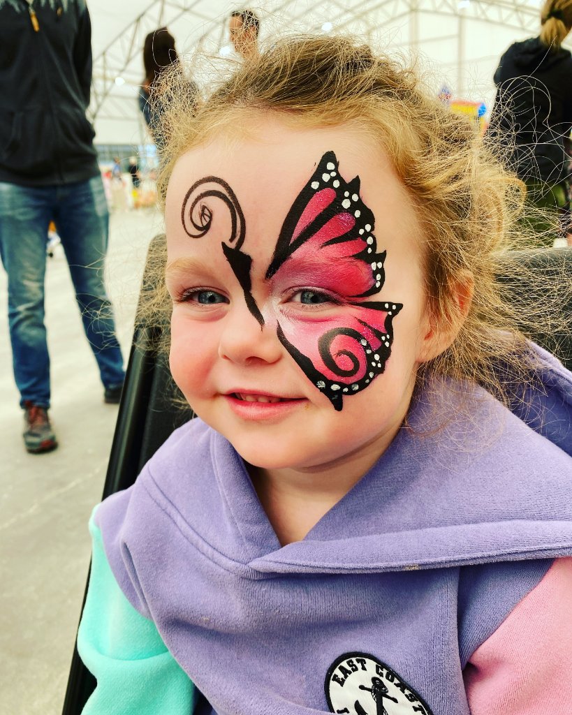 Colourful face painting by The Flow and Arts at a Calgary celebration