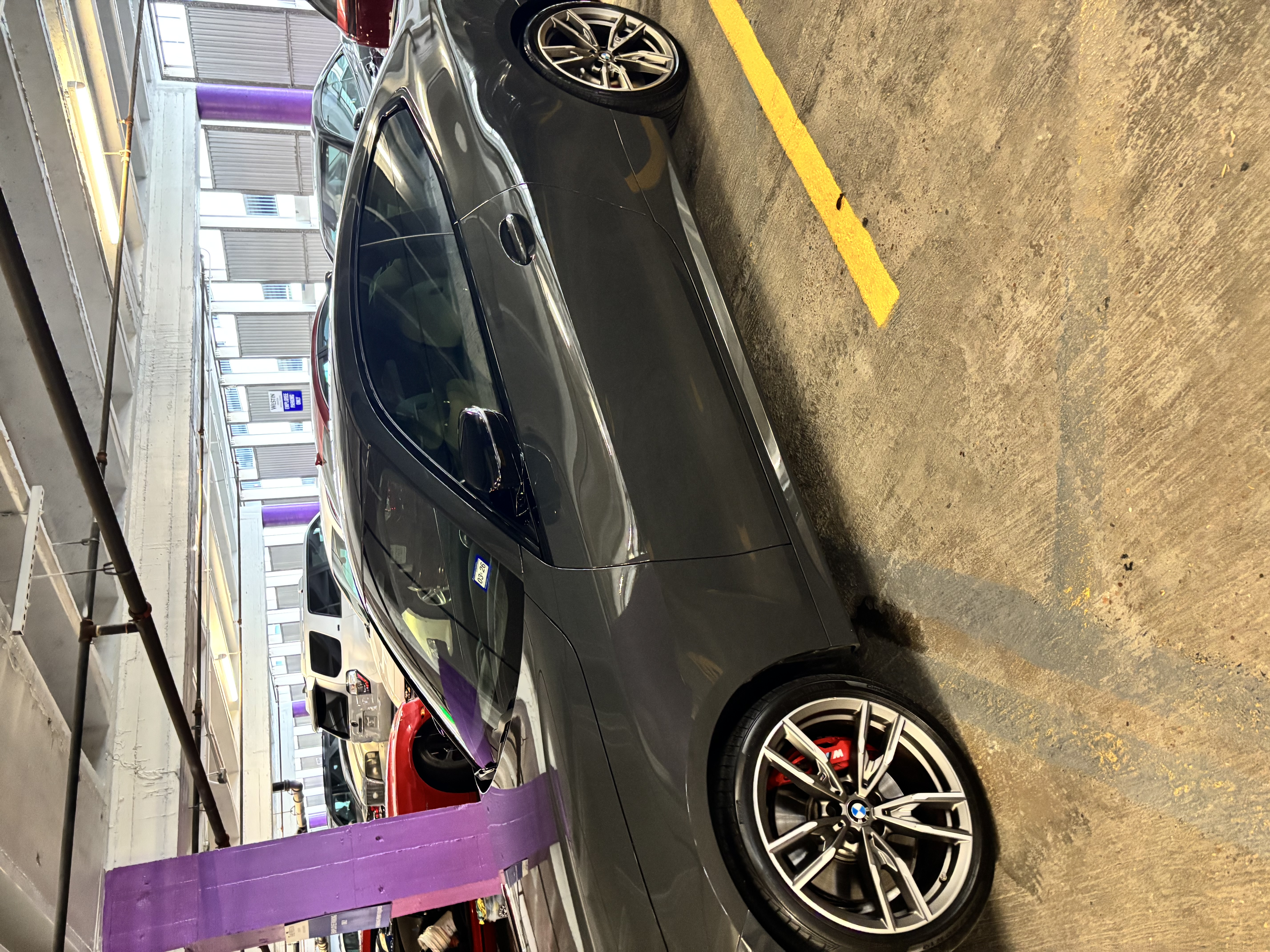 Dark grey BMW in parking garage