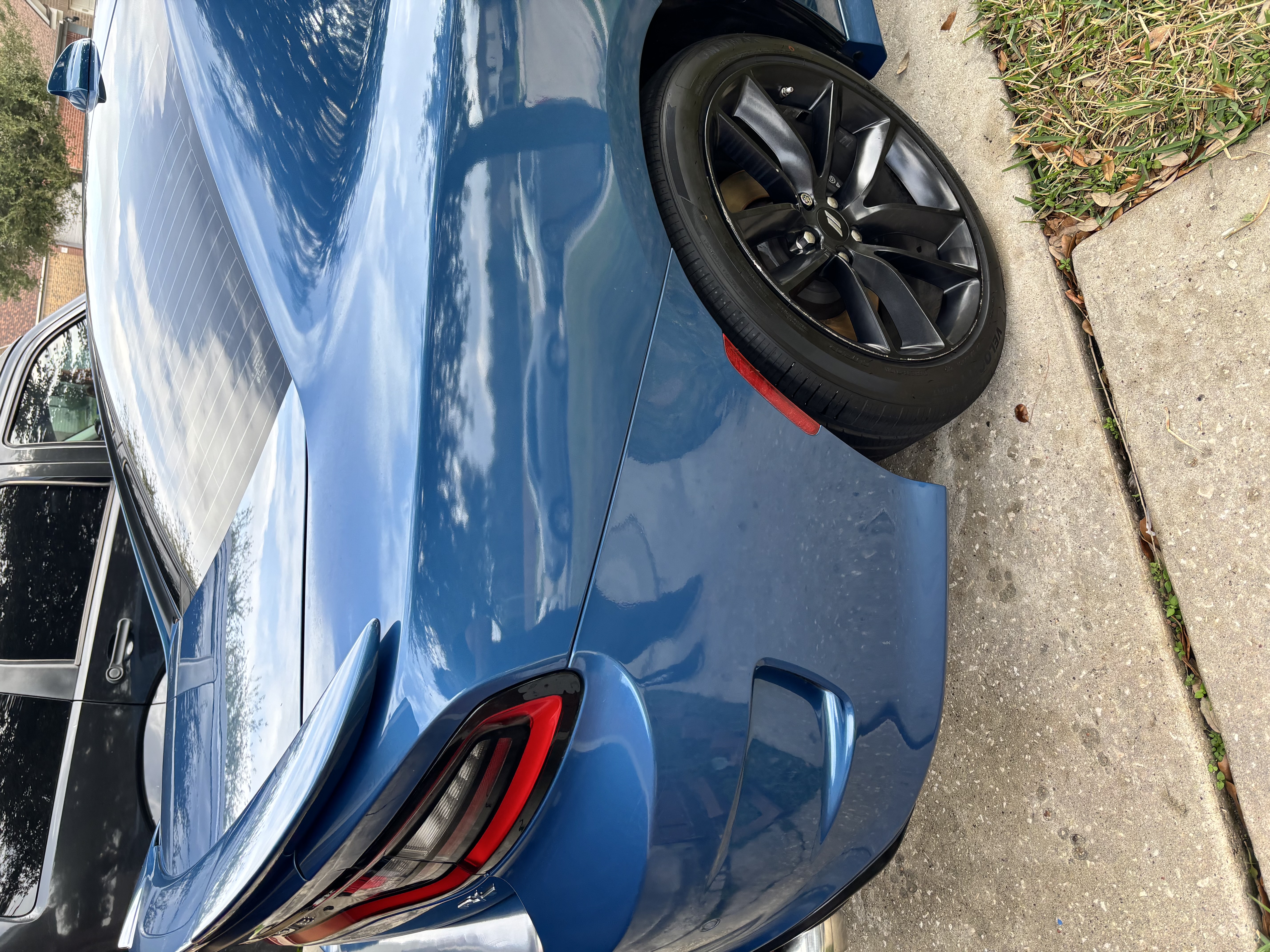 Blue sports coupe rear quarter