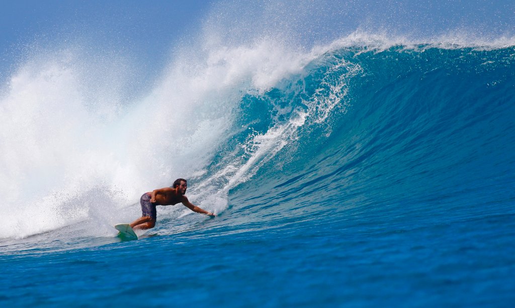 Surfer riding a wave in Maui