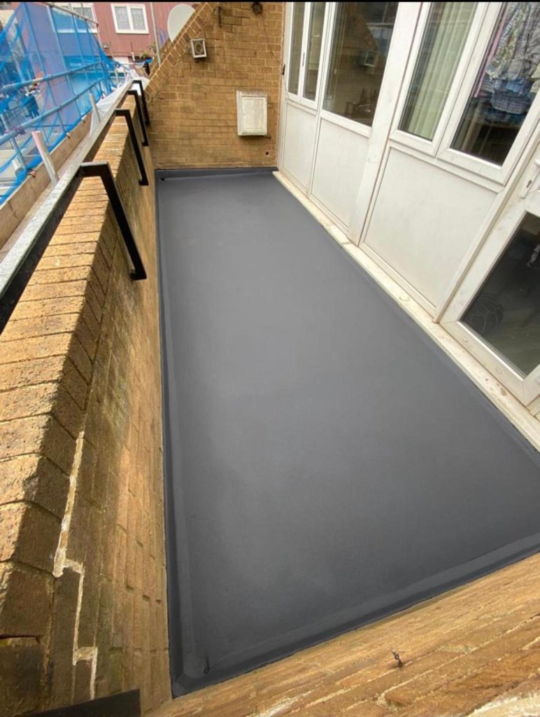 Completed residential terrace waterproofing — smooth grey membrane finish, small-area application