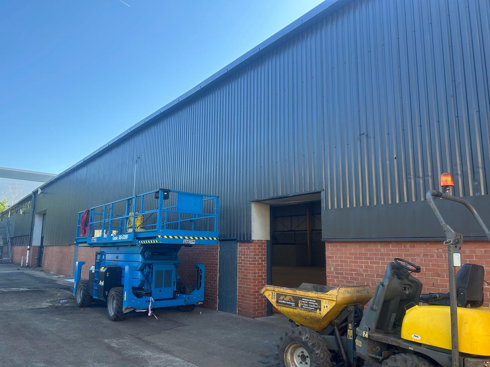 Industrial wall coating with scissor lift access