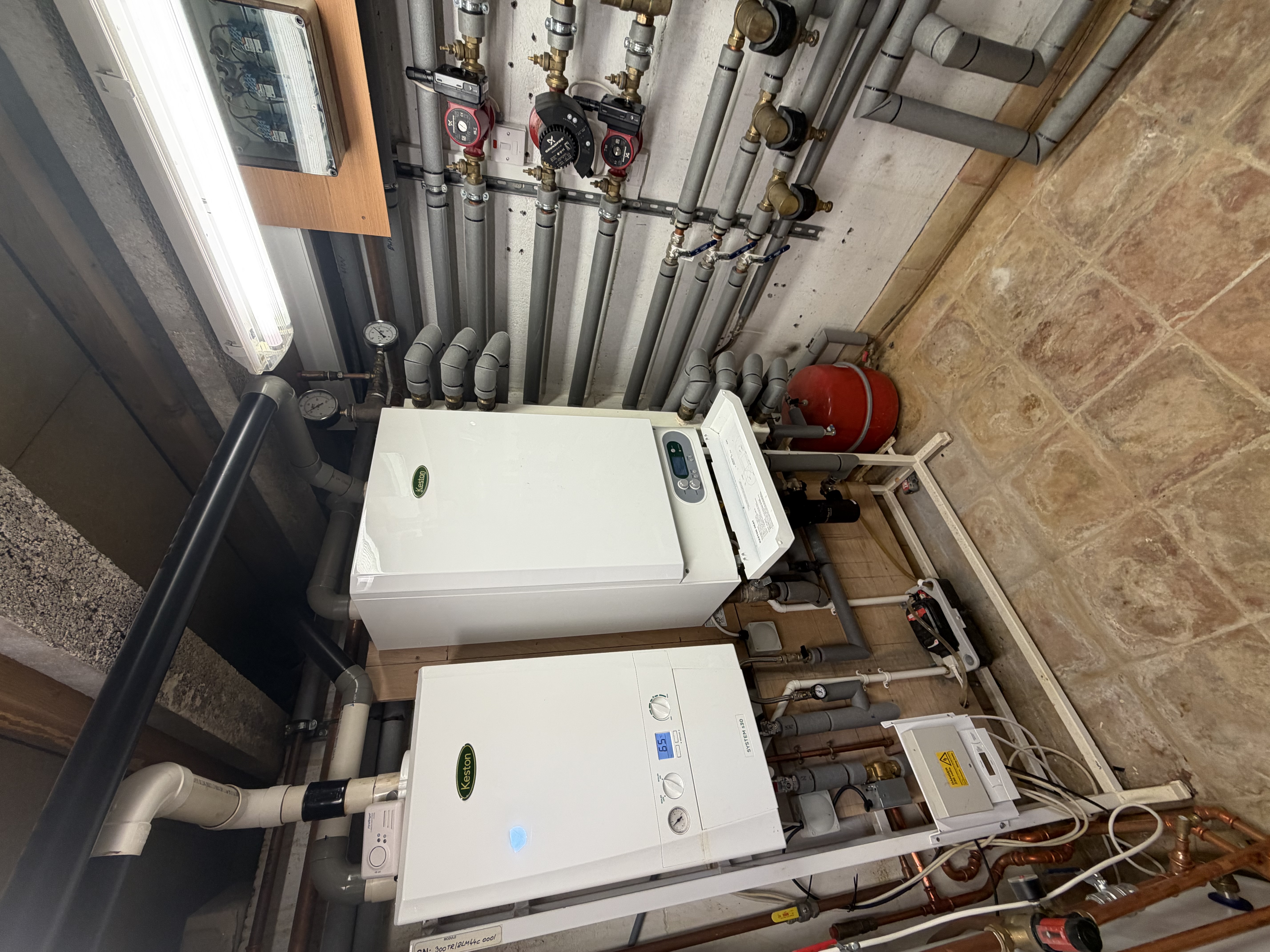 RARE Plumbing London engineer installing system boilers in a London plant room