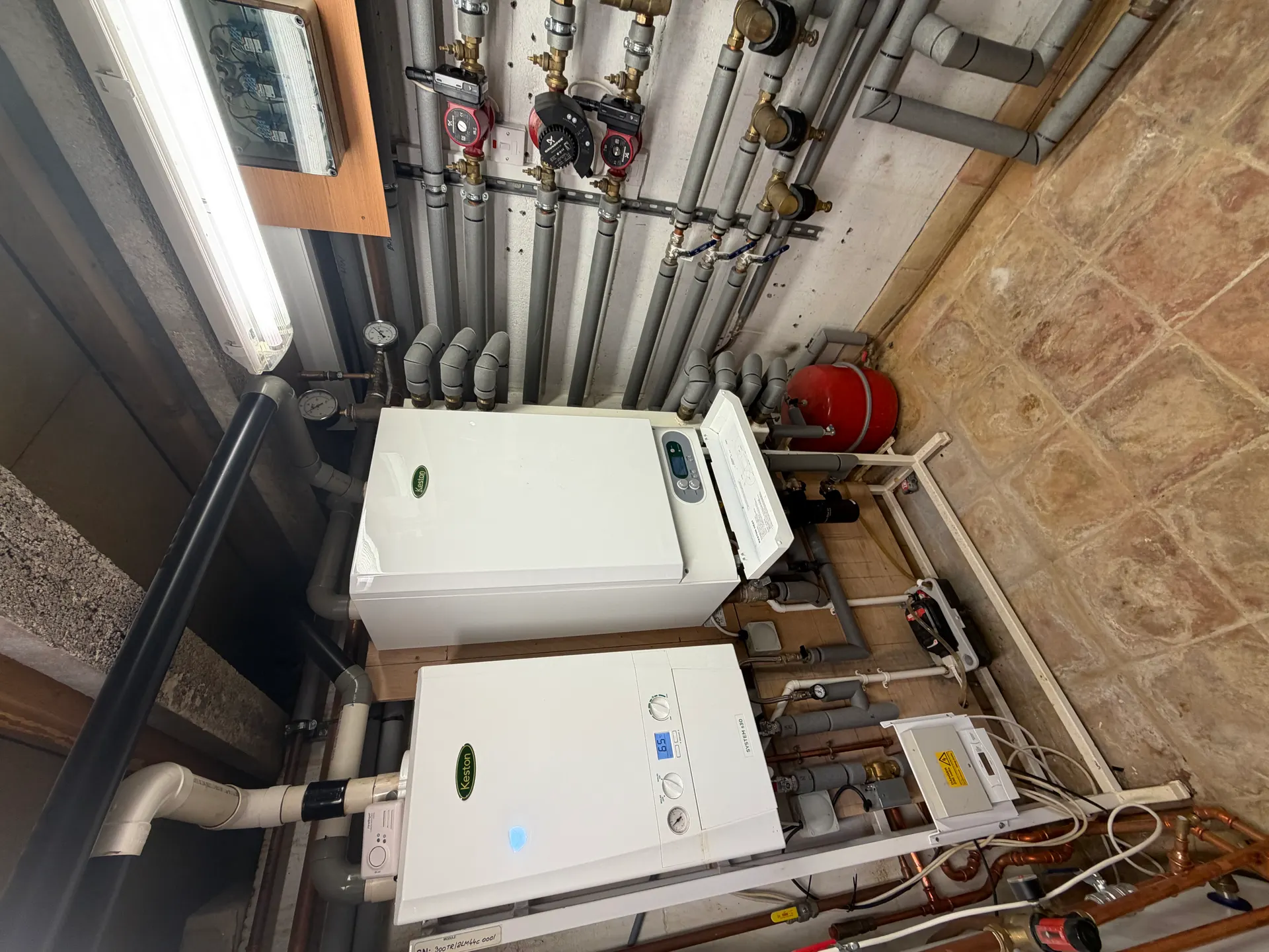 Rebuilt plant room with cascade system boilers, Grundfos pumps and insulated pipework
