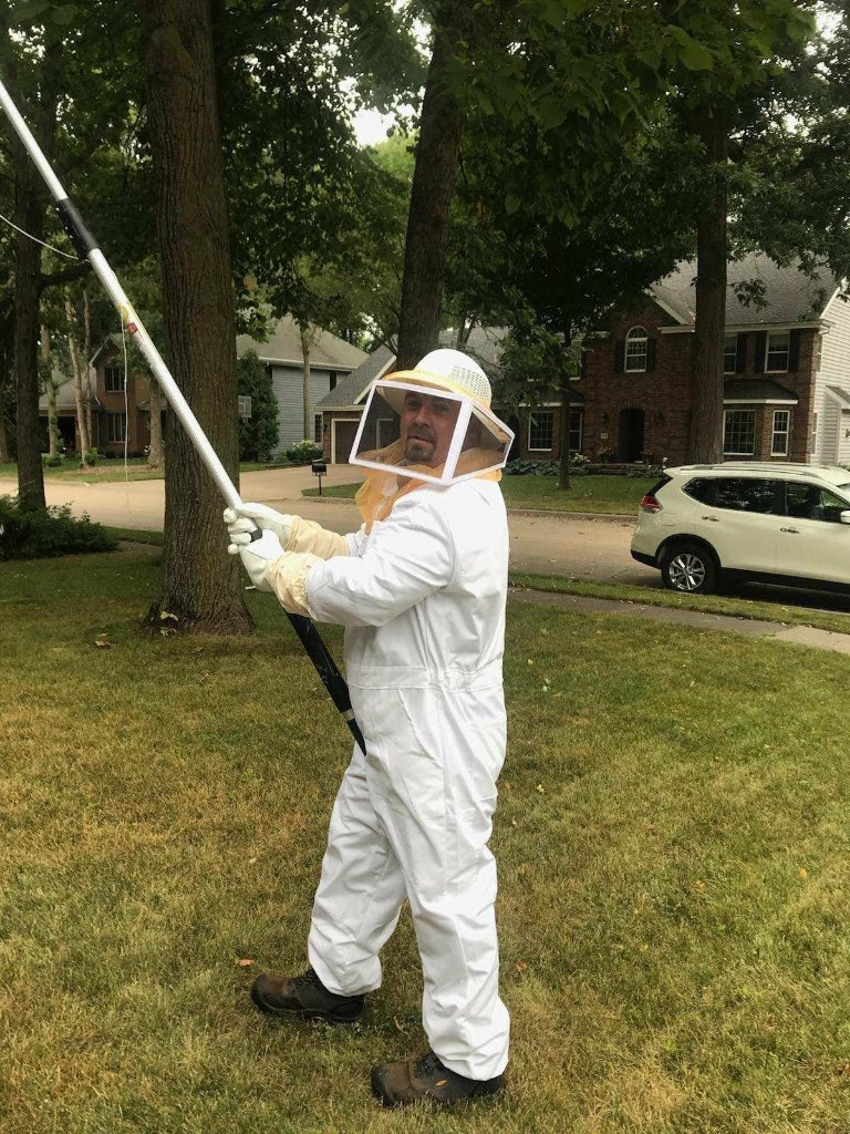 Adam Sager — Mid State Pest Control owner treating a wasp nest in Northeast Wisconsin