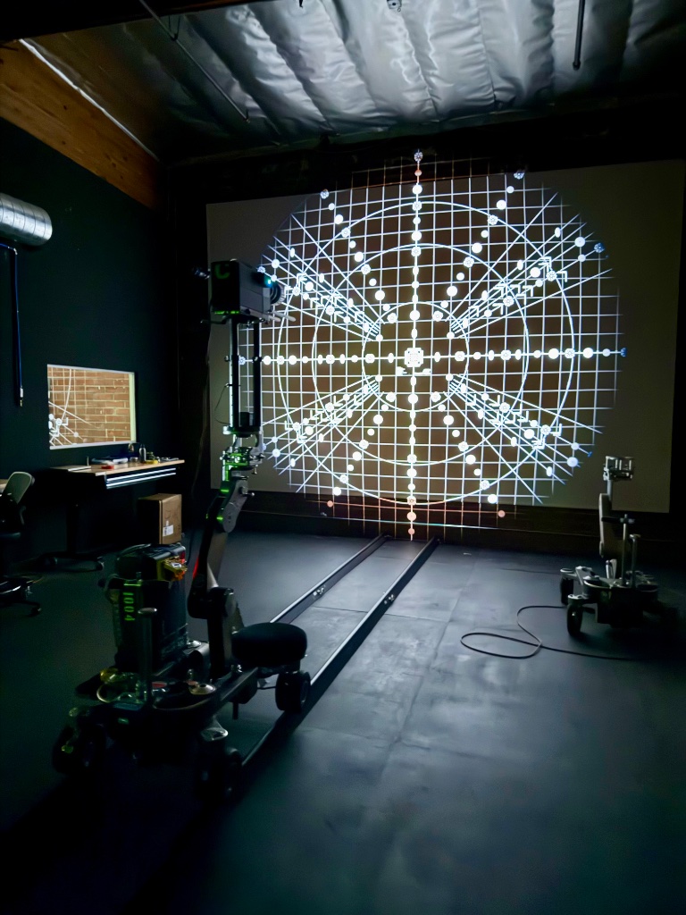 Optical calibration lab with lens projection grid on screen