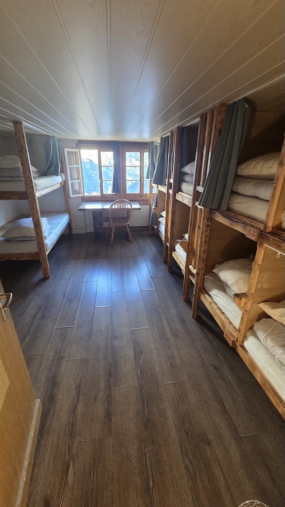 Dormitory room with bunk beds and mountain view window