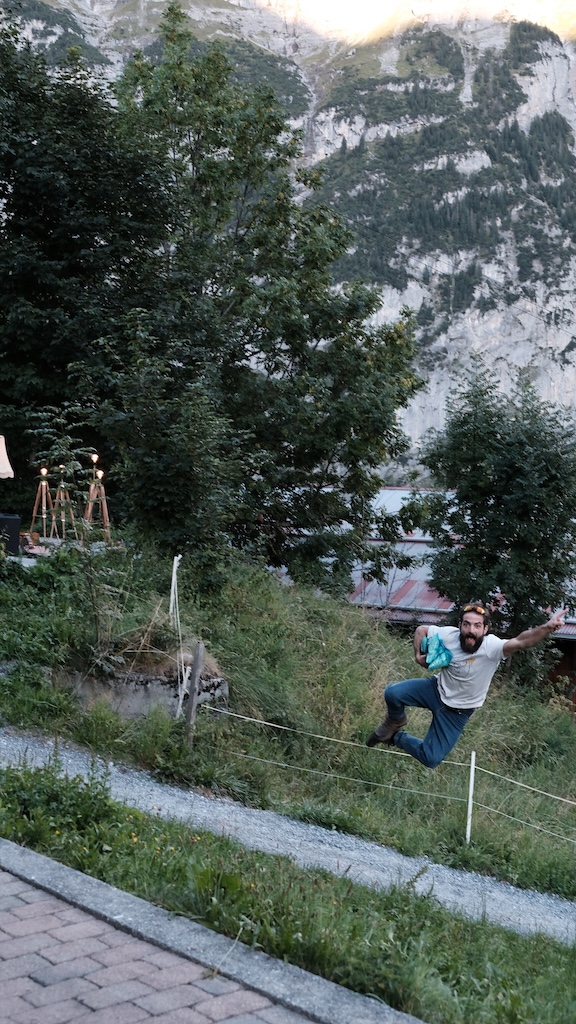 Staff member leaping over a fence in the garden