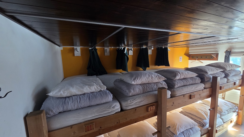 Multi-tiered wooden bunk beds with privacy curtains