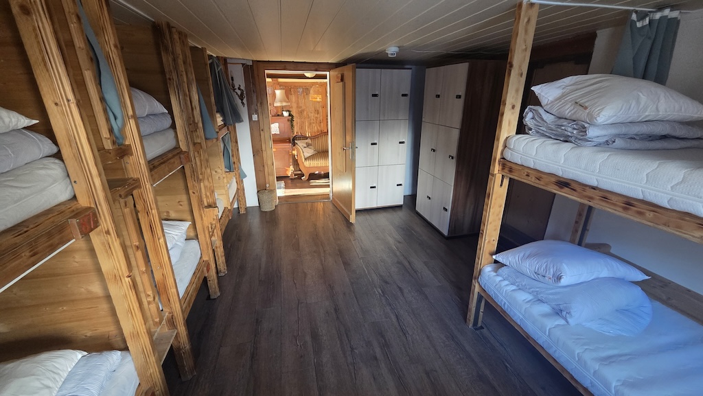 Dormitory with wooden bunk beds and storage lockers