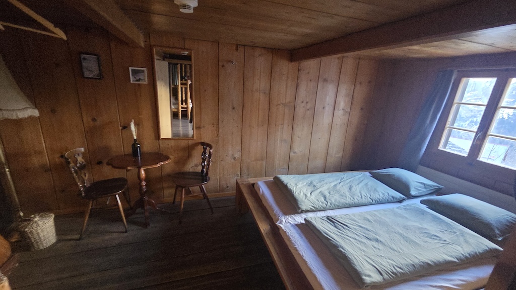 Private double room with wood paneling and garden view
