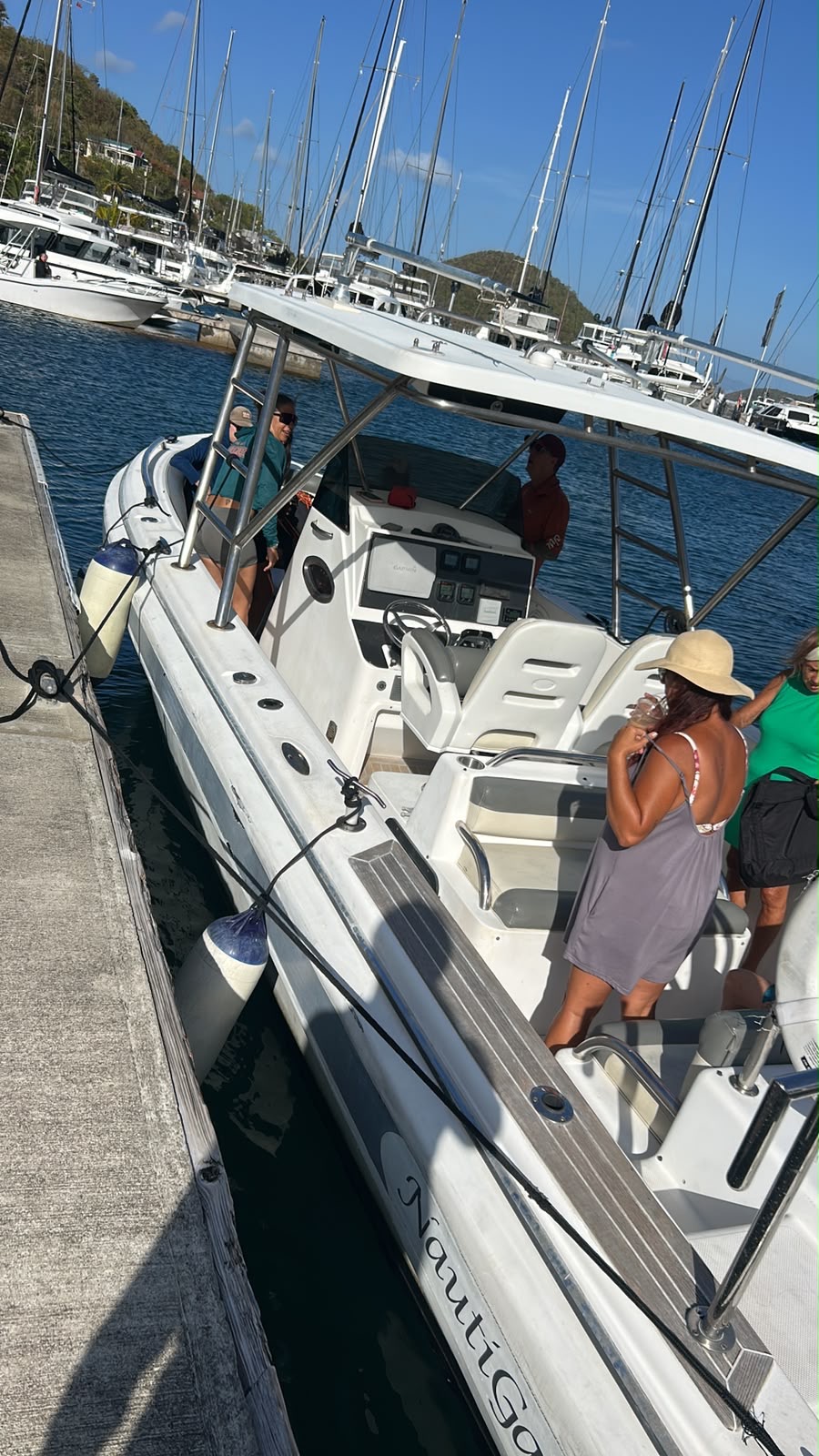 White center-console boat at the dock