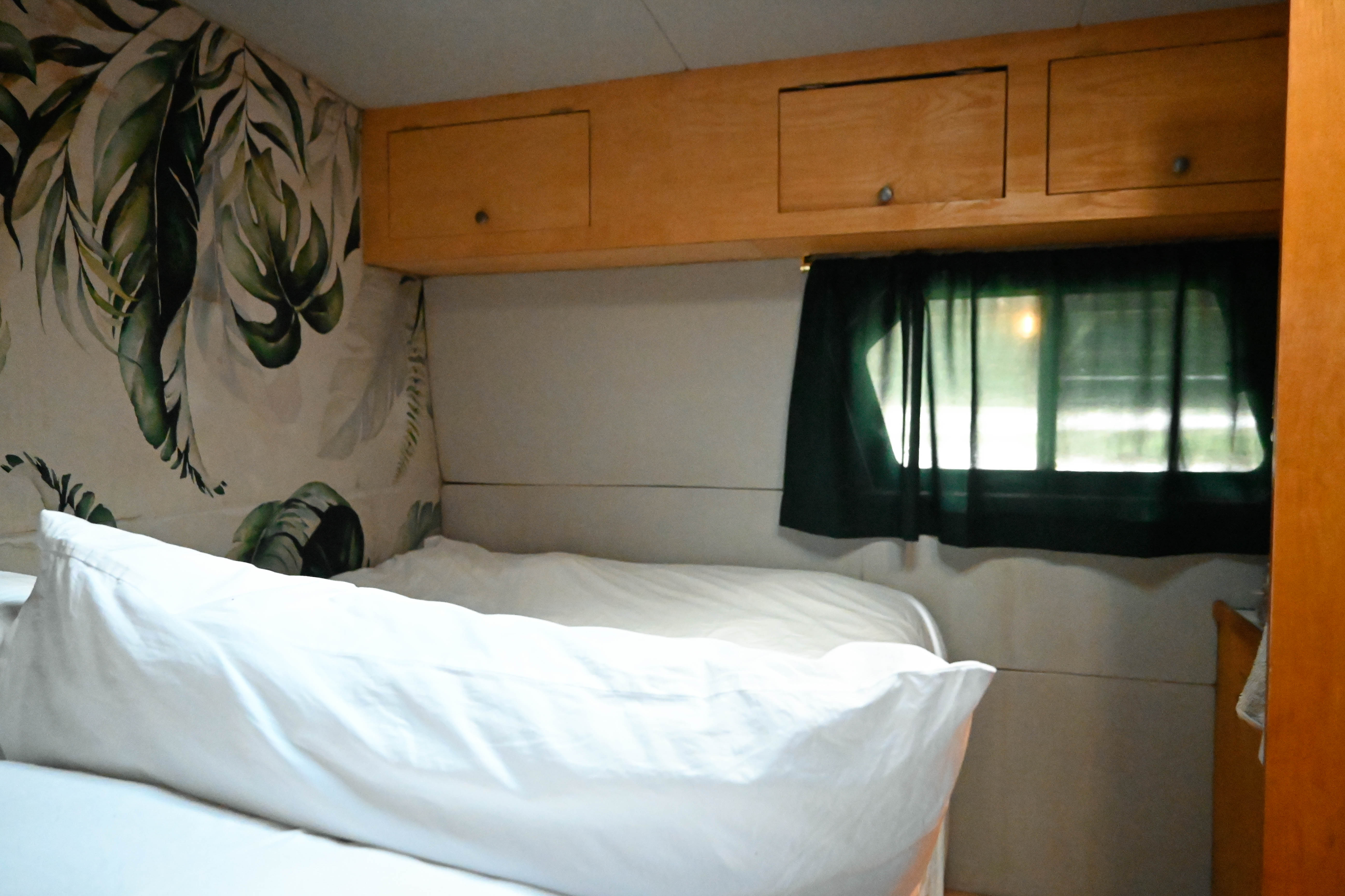 Bus bedroom with tropical wallpaper