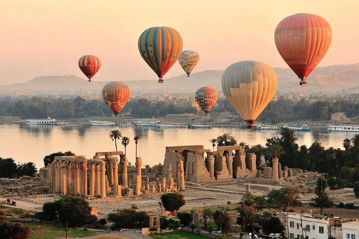 Hot air balloons over Luxor temples and the Nile at sunrise