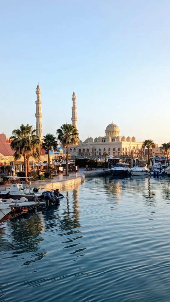 Hurghada marina at golden hour with mosque and boats