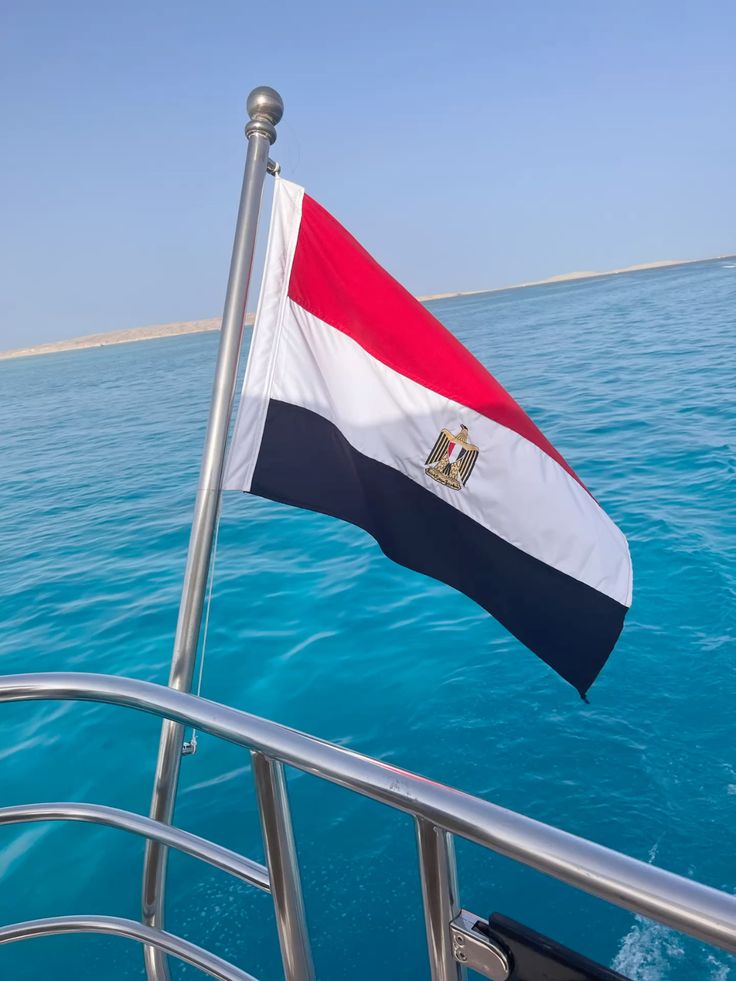 Egyptian flag flying over the crystal blue Red Sea